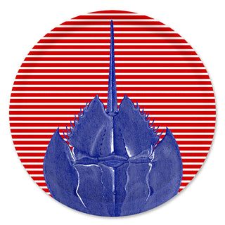 The Caskata Horseshoe Crab Large Round Birchwood Tray features a blue horseshoe crab on a red and white striped circular background, echoing vibrant Finnish design.