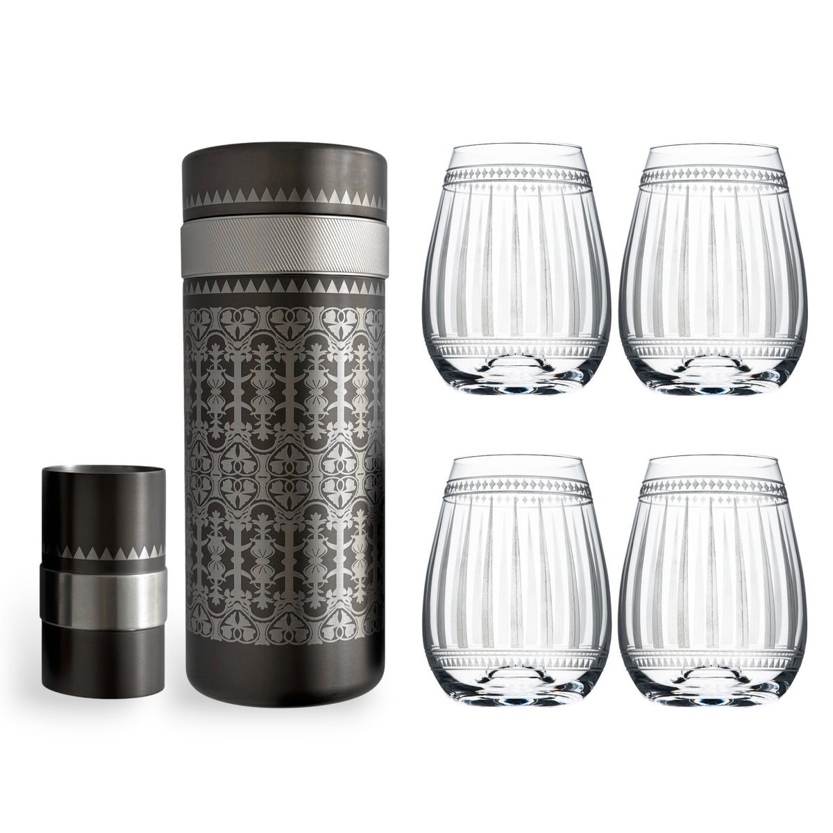 The Art Deco Bar Bundle by Caskata features four clear patterned stemless wine glasses and an ornate metallic cocktail shaker with lid—an elegant barware set for your home.