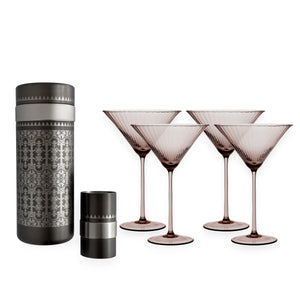 The Caskata Smoky Quartz Bar Bundle features a silver and black cocktail shaker set, four matching martini glasses, and a small cylindrical accessory—all with an intricate geometric pattern.