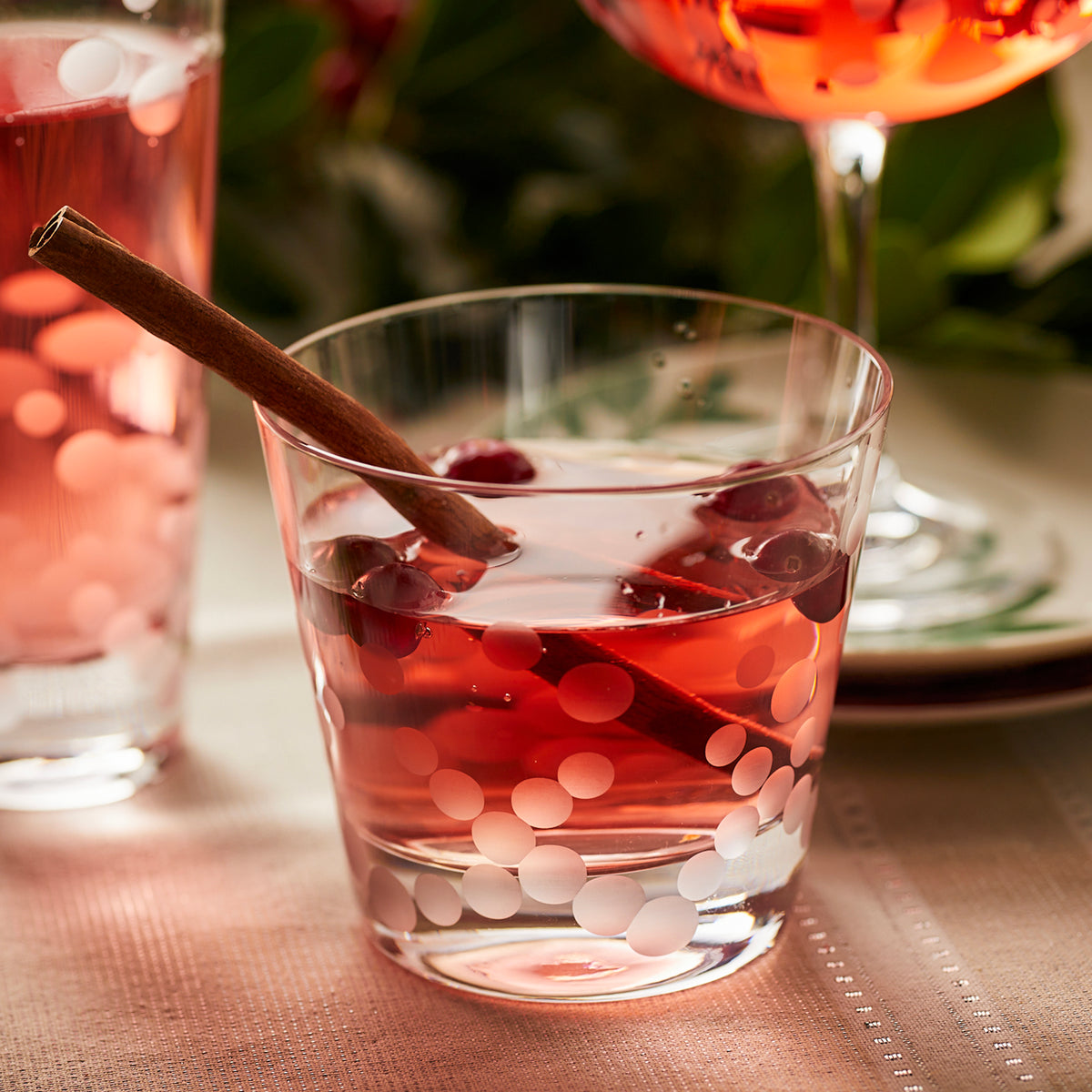 A glass of Chatham Pop Tumblers cranberry juice with a polka-dot pattern.