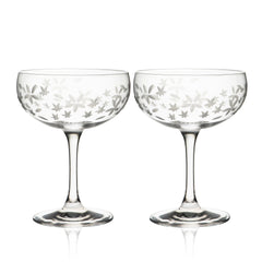 A pair of Chatham Bloom Coupe Cocktail Glasses with a delicate floral pattern. (Brand: Caskata)