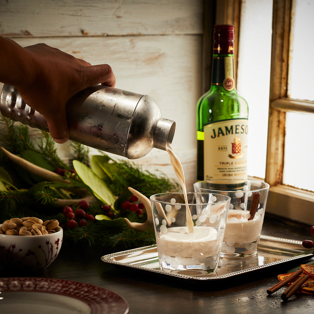 A bottle of Jameson being poured into a Caskata Chatham Pop Tumbler made of lead-free crystal, showcasing its retro shapes.