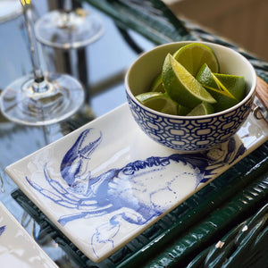 A Newport Snack Bowl filled with a vibrant arrangement of limes, creating a graphic pop, from Caskata Artisanal Home.