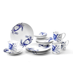 A blue and white Crab Table for 4 dinner plate set with crabs on it by Caskata.