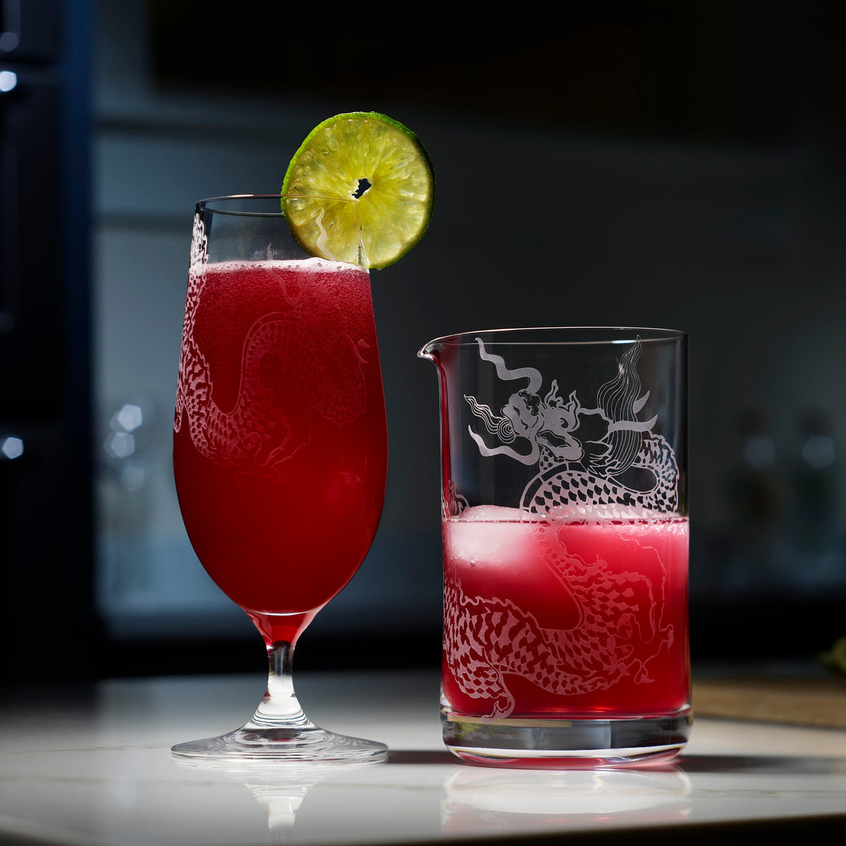 A vibrant pink cocktail is featured in sand-etched dragon mixing and beer glasses. 