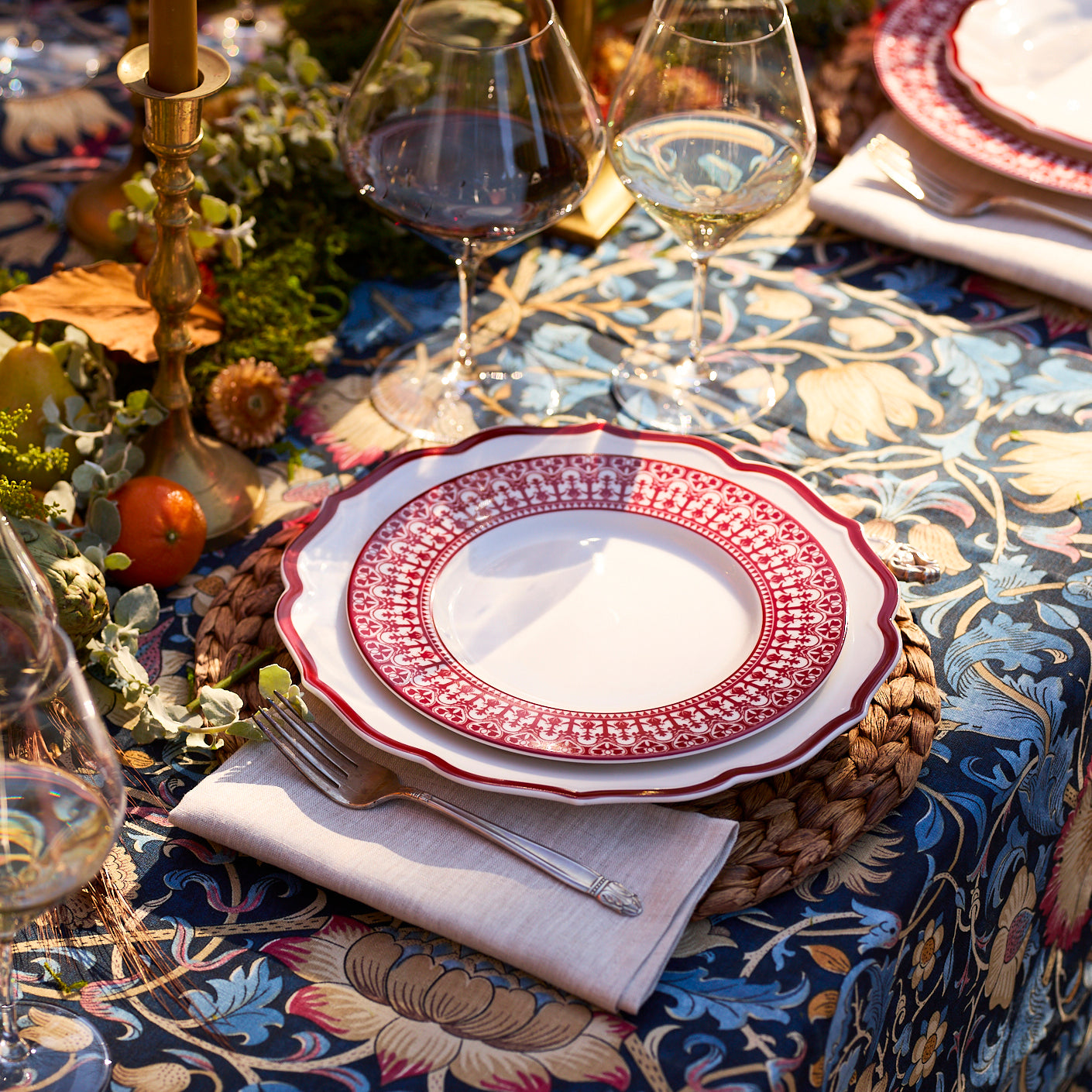 The Stella Scalloped Crimson Dinner Plate by Caskata is an heirloom-quality, high-fired porcelain plate with a scalloped edge and a bold red border, shown from above against a plain background.