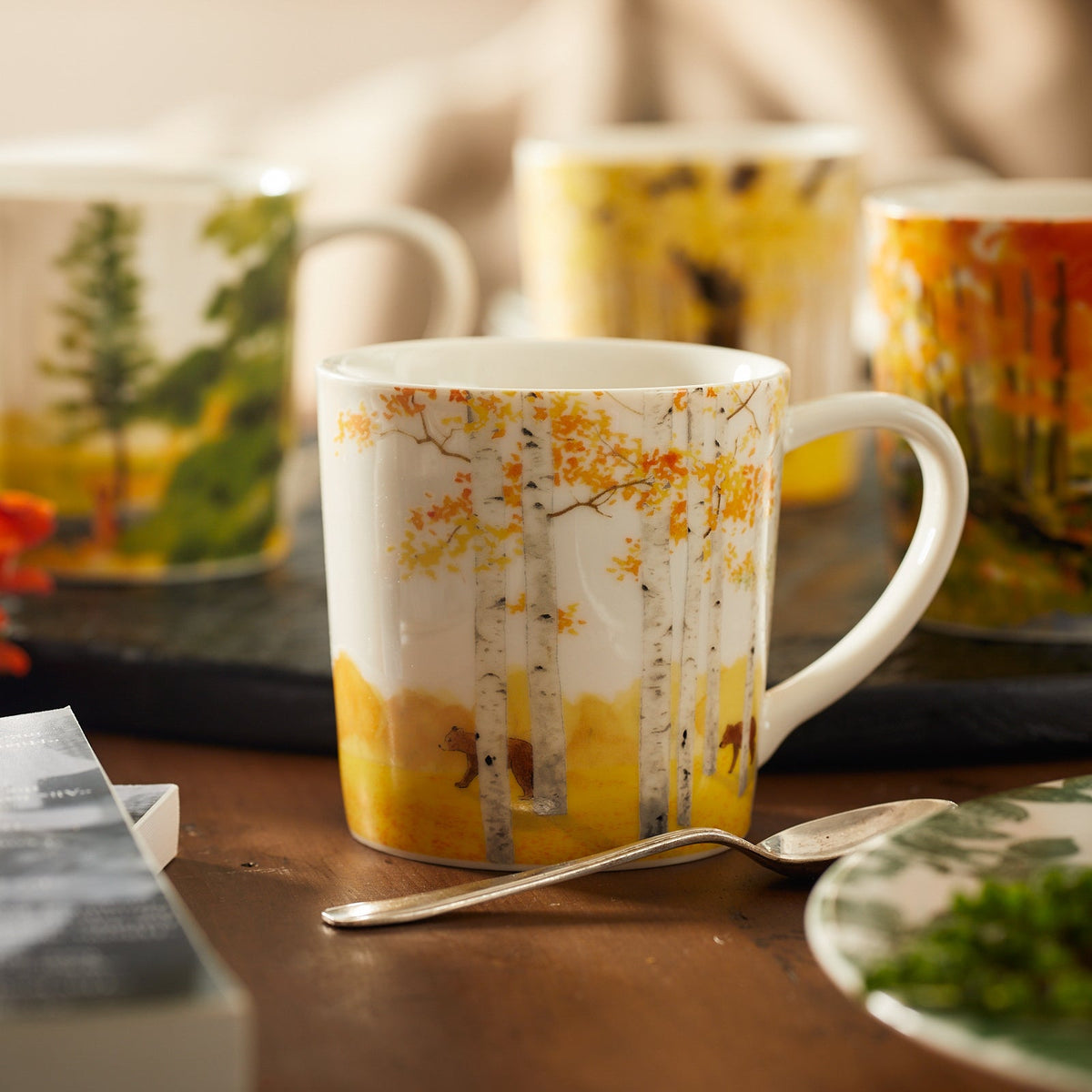 A close up shot of the birch tree and bear pattern of the Caskata X Felix Dolittle Autumn Collaboration Porcelain Mug Set of 4