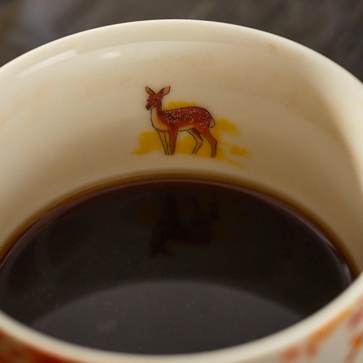 A detail of the deer on the inside of the Caskata X Felix Dolittle Autumn Collaboration Porcelain Mug Set of 4