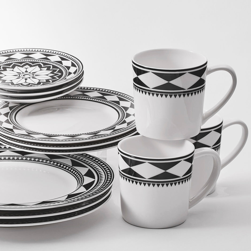 A Fez Table for 4 dinnerware set on a white surface featuring a Morrocan-inspired table set by Caskata.