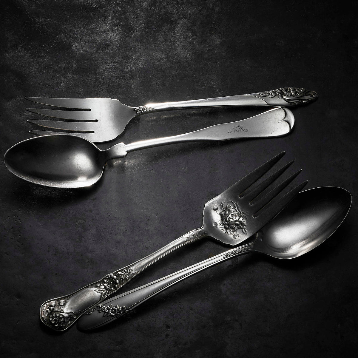 Caskata Brimfield Vintage Serving Set spoon and fork on a black surface.
