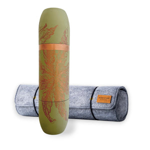 The Caskata X High Camp Flasks Freya Flask and Case Bundle by Caskata features a green, cylindrical stainless steel flask with a leaf design, standing before a gray felt case with tan leather label and magnetized cups.