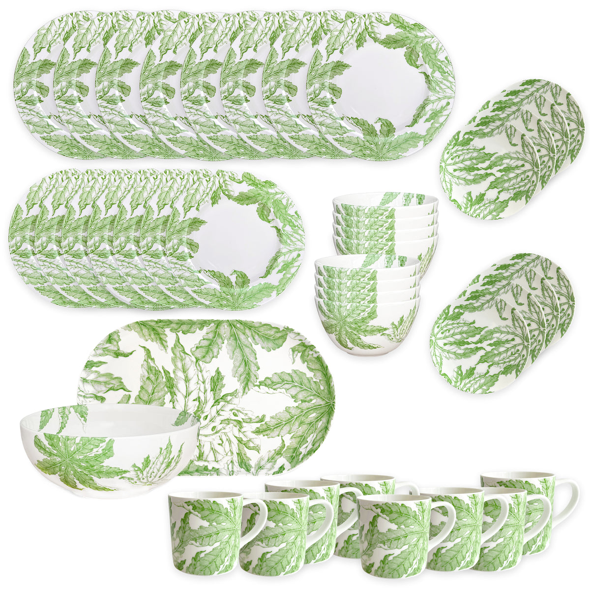 The Caskata Freya Ultimate Set is a 42-piece porcelain dinnerware collection with plates, bowls, and mugs in a green leafy pattern on white. Dishwasher and microwave safe, it's beautifully arranged on a white surface.