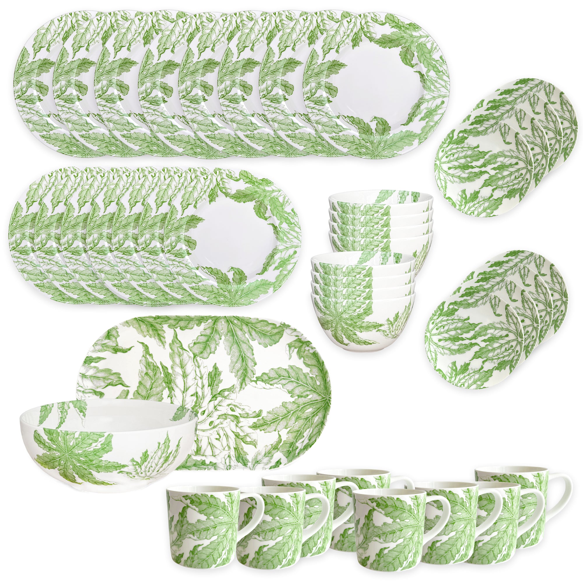 The Caskata Freya Ultimate Set is a 42-piece porcelain dinnerware collection with plates, bowls, and mugs in a green leafy pattern on white. Dishwasher and microwave safe, it's beautifully arranged on a white surface.