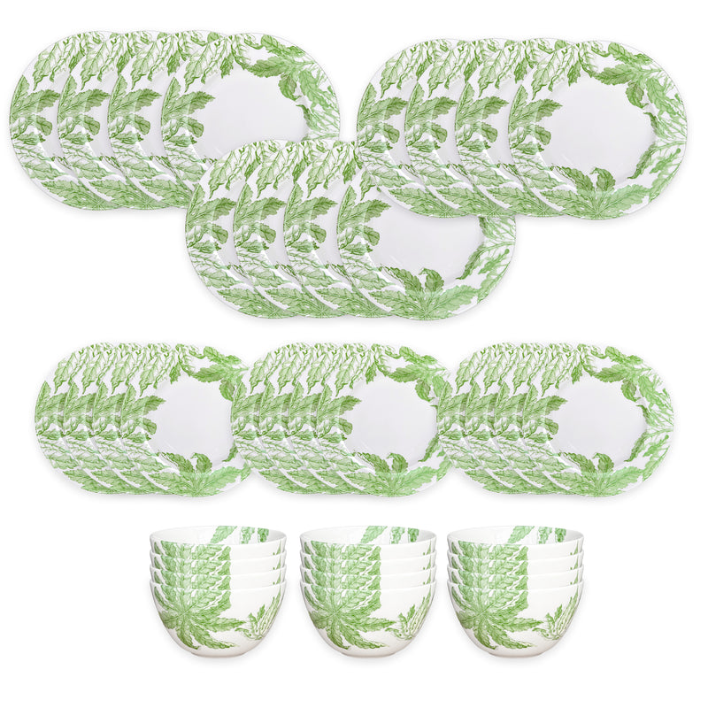 The Caskata Freya Table for 12 is a 36-piece porcelain dinnerware set with white plates and bowls adorned with green fern leaf patterns. Dishwasher and microwave safe, it offers everyday convenience and style.