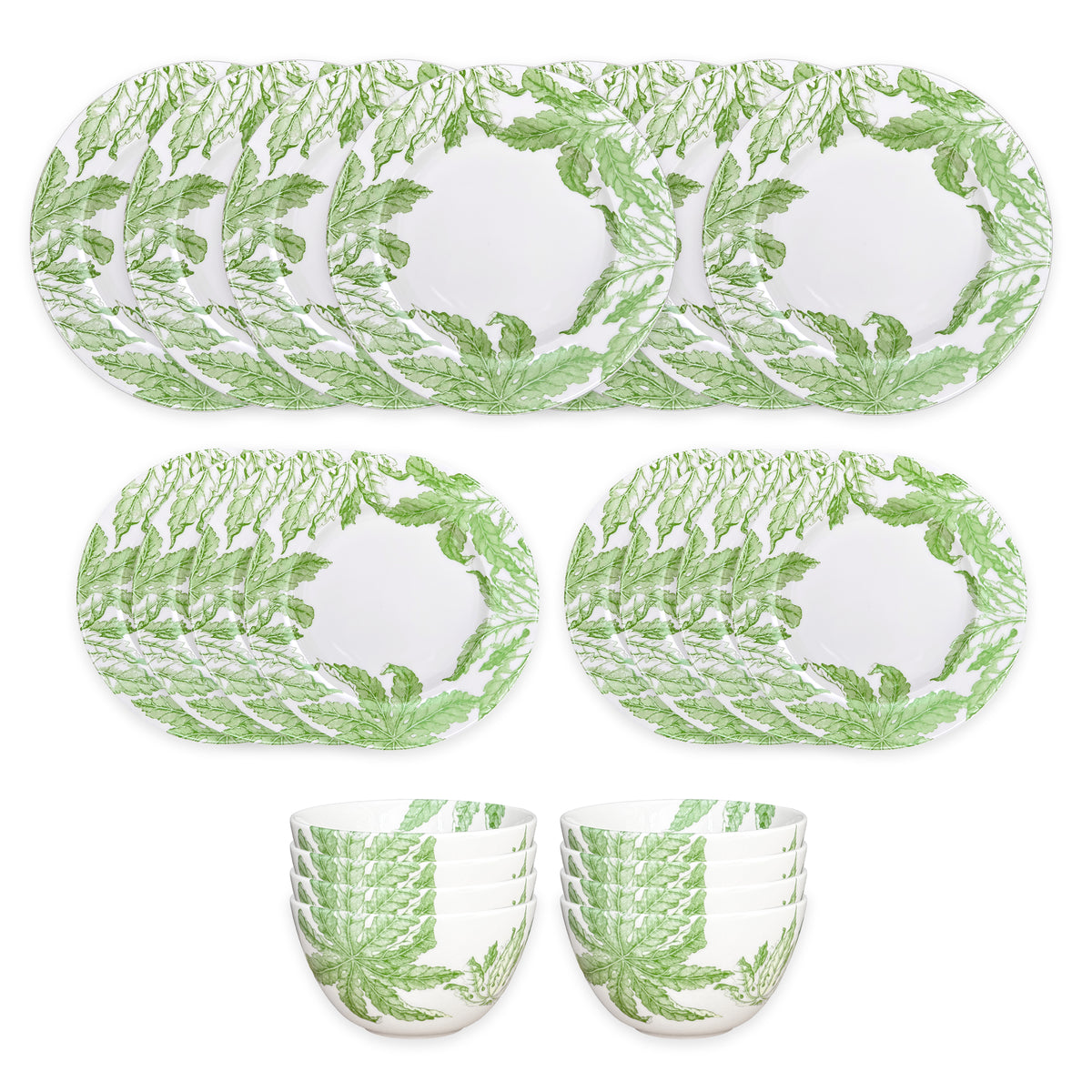 The Caskata Freya Table for 8 is a 24-piece porcelain dinnerware set with green leafy patterns on white; includes plates and bowls that are both dishwasher and microwave safe for convenience.