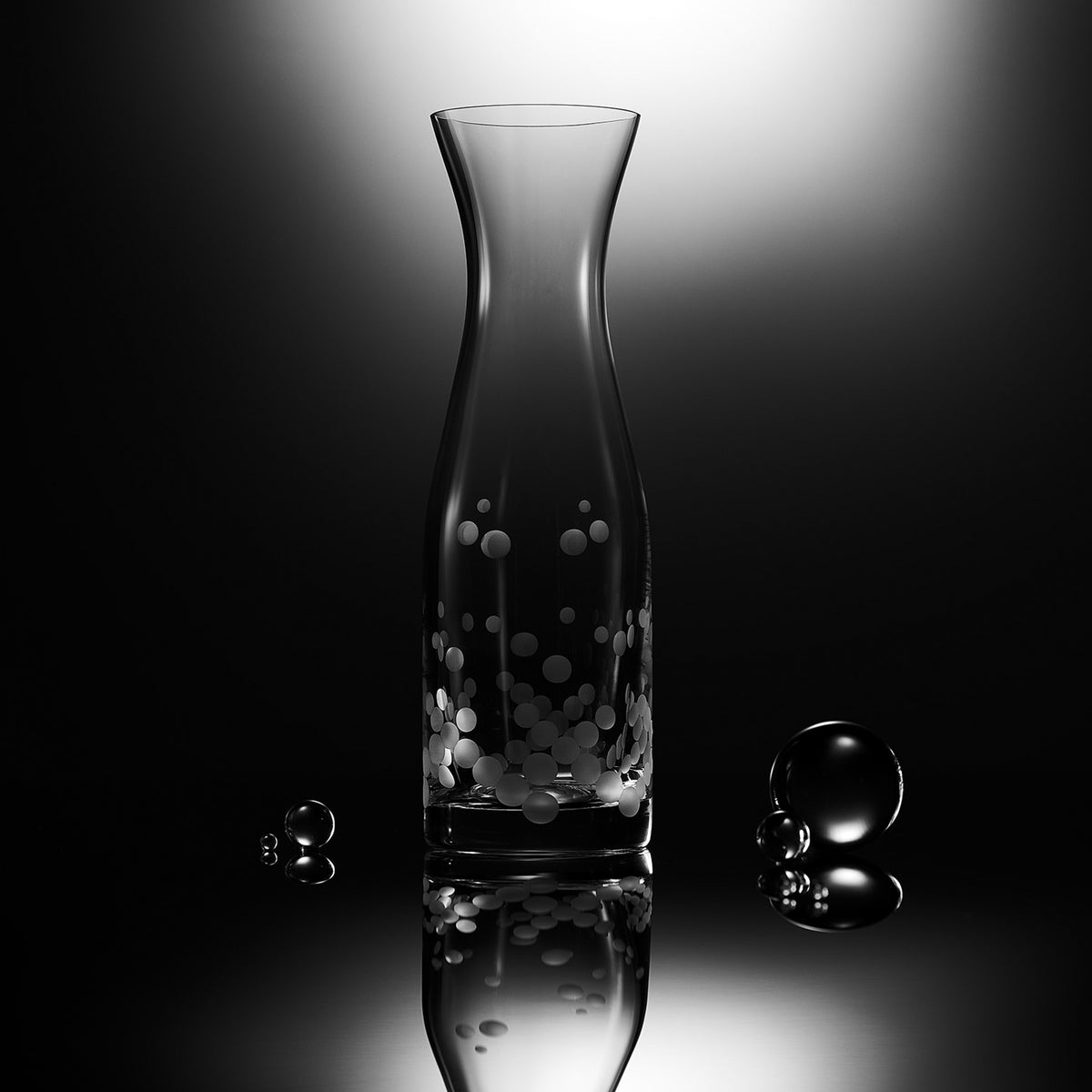 The Chatham Pop Glassware Bundle by Caskata includes a tall transparent glass vase with bubble patterns and three reflective spheres, set against a black and white backdrop. Made from lead-free crystal, it&#39;s perfect for any cocktail lover&#39;s decor.