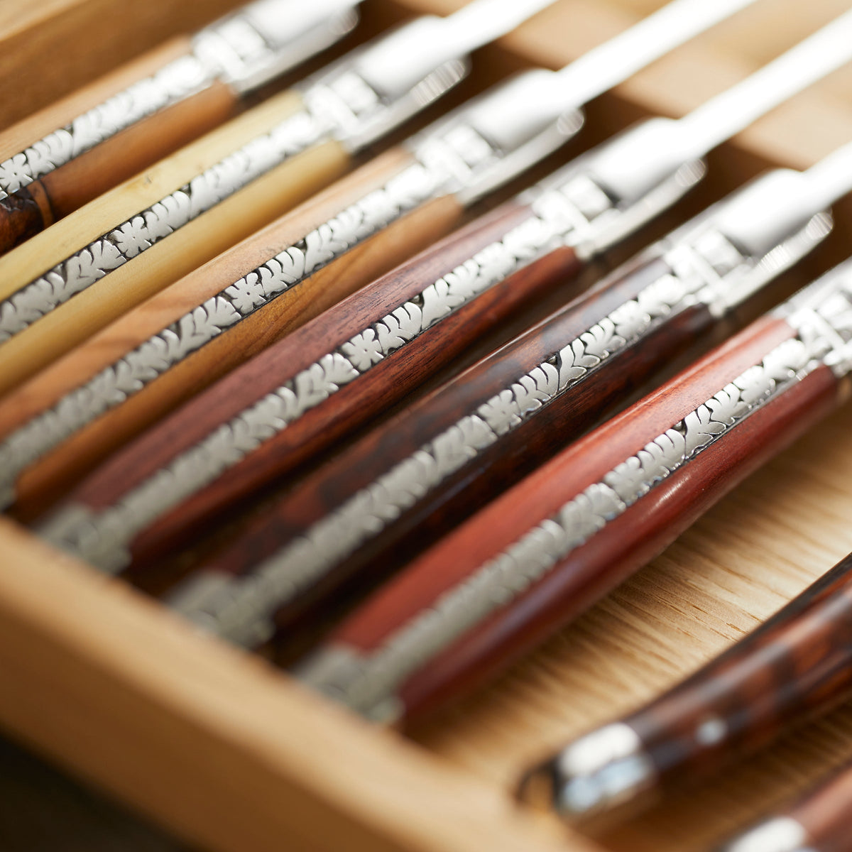 A set of Goyon-Chazeau Mixed Wood Le Thiers Steak Knives Boxed Set/6 beautifully crafted in noble wood and packaged in a wooden box.