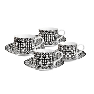 The Caskata Casablanca Cups & Saucers Set of 4 features bone china teacups and matching saucers with a bold black scrollwork design, elegantly displayed on a white background.