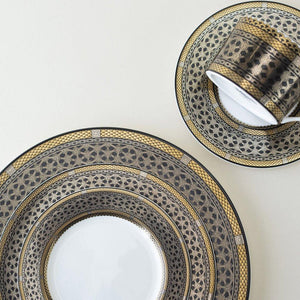 A Hawthorne Onyx Gold & Platinum Cup & Saucer Set by Caskata Artisanal Home with a pattern on it.