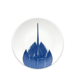 The Horseshoe Crab Coupe Salad Plate by Caskata Artisanal Home is a contemporary porcelain plate that elegantly showcases a blue illustration of a horseshoe crab.