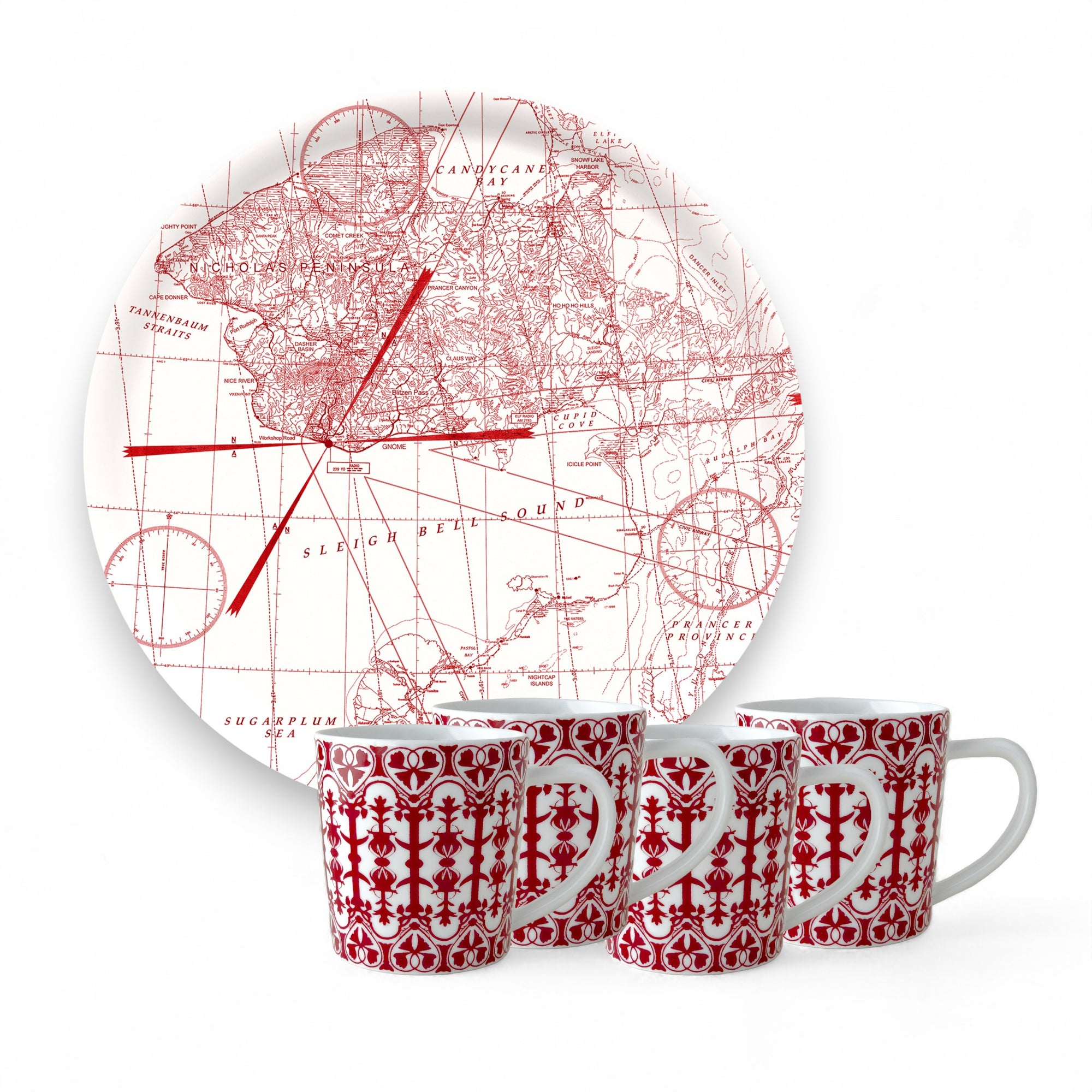 The Caskata "Holiday Cocoa" Bundle features four white porcelain mugs with red geometric patterns, placed in front of a birchwood serving tray adorned with a red vintage map design, all set against a white background.