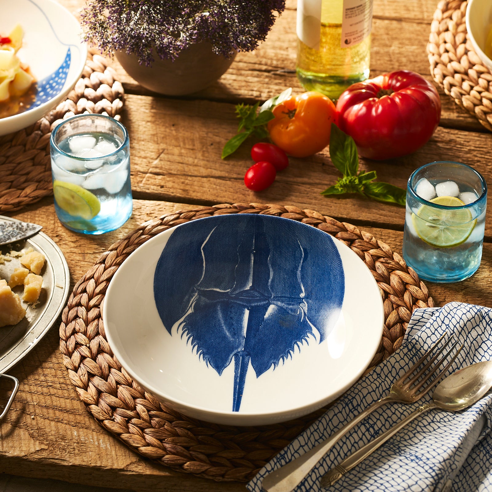 The Caskata Horseshoe Crab Entrée Bowl features a white porcelain design with a blue horseshoe crab illustration inside, making it perfect for serving soup or adding coastal charm to your New England kitchen.