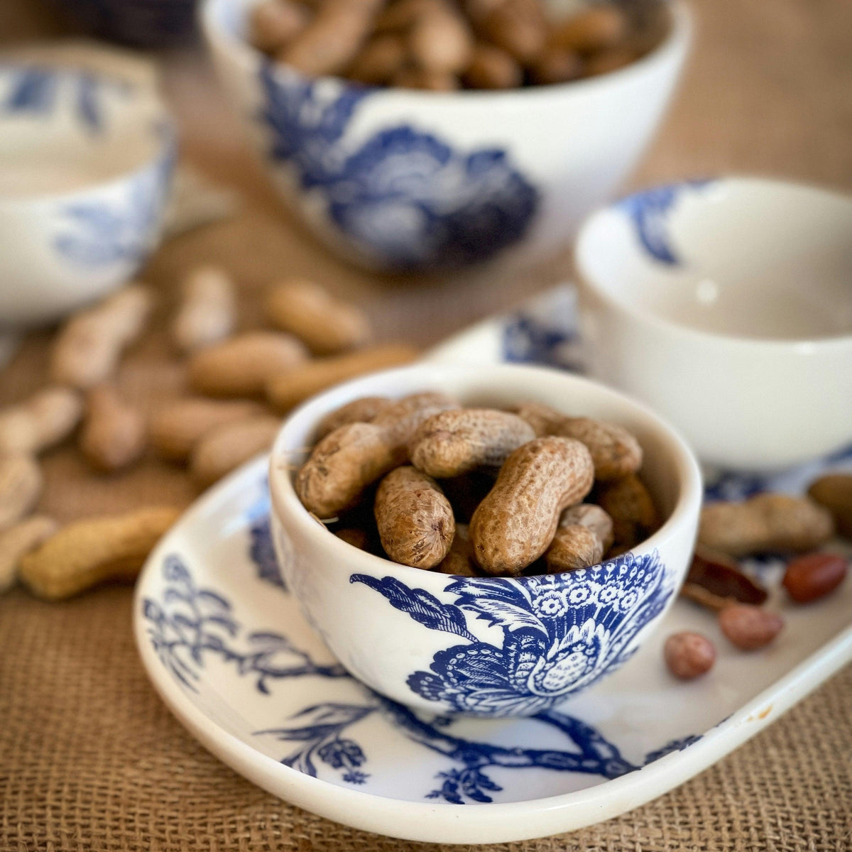 Arcadia Snack Bowls in blue and white on a table for outdoor activities by Caskata Artisanal Home.