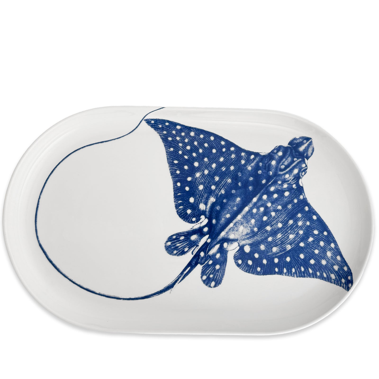 The "Ray" the Stingray Large Coupe Oval Platter by Caskata is a white porcelain piece from the coastal collection, featuring a blue illustration of a spotted eagle ray.