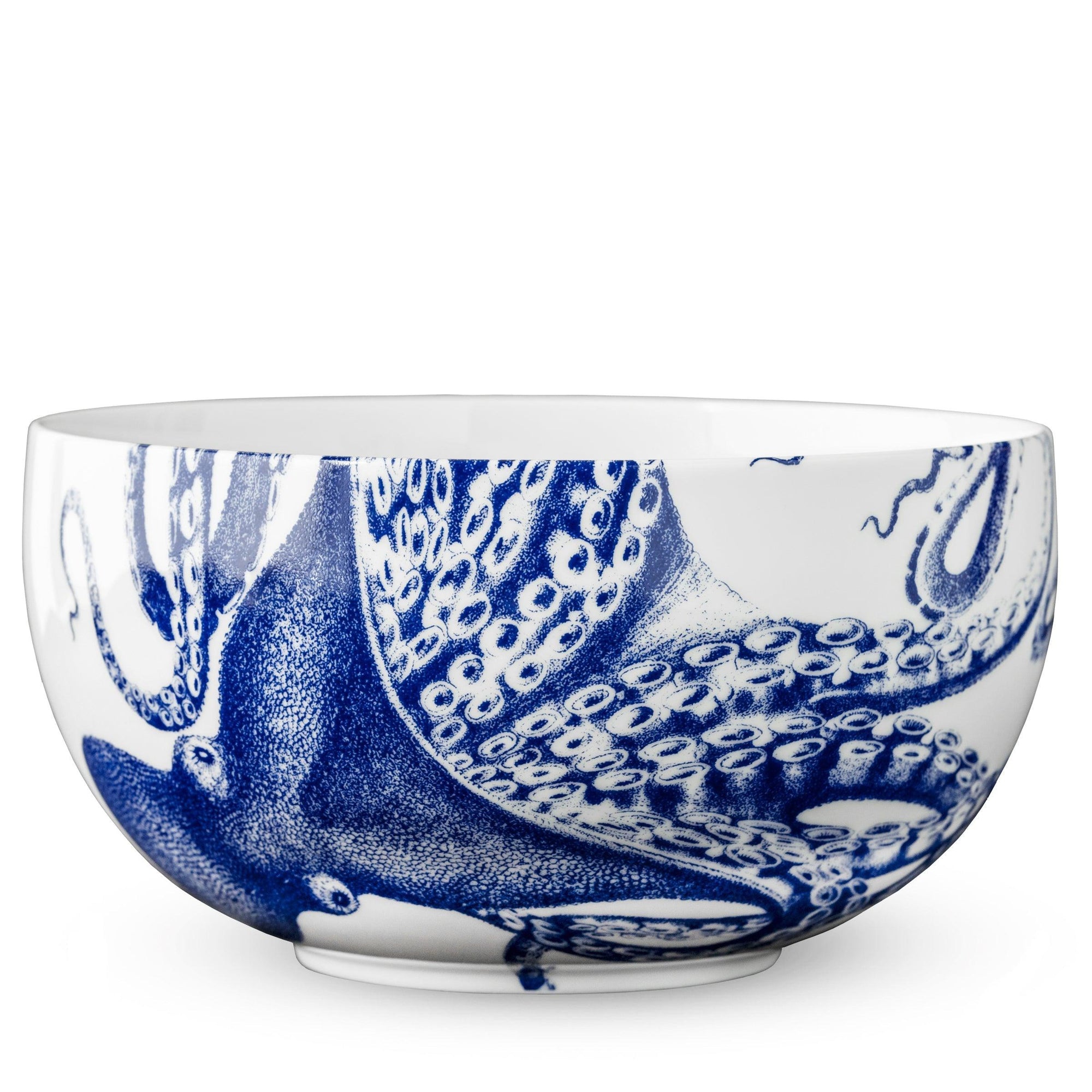 A blue and white porcelain Lucy Large Round Serving Bowl with an octopus signature motif from Caskata Artisanal Home.