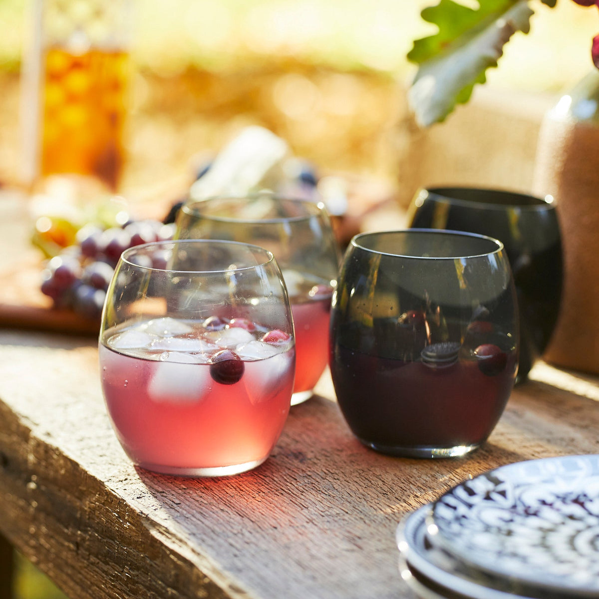 Three Les Nuages Gray Ombré Glasses Set of 4 tumblers on a wooden table.