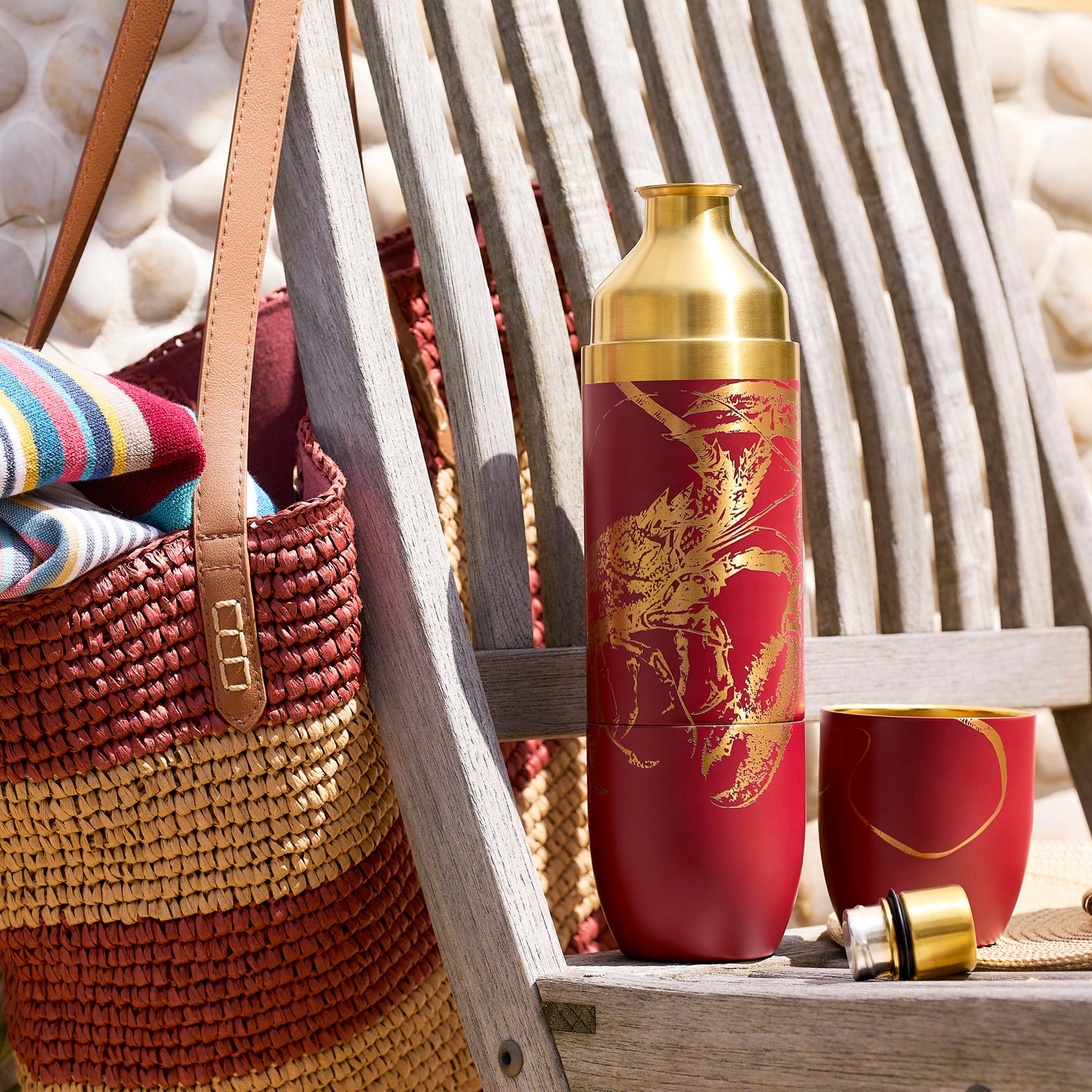Caskata’s Summer Adventures Flask Bundle features three insulated wine bottles—lobster on red, knots on white, fish on blue—displayed by a pool with sunglasses and a towel for the perfect stylish summer set.