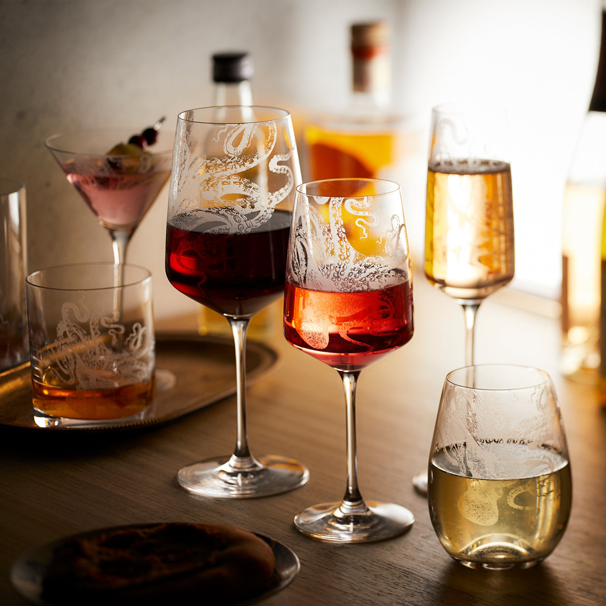 A group of Lucy White Wine Glasses by Caskata Artisanal Home, hand washing, lead-free Crystal wine glasses on a table.