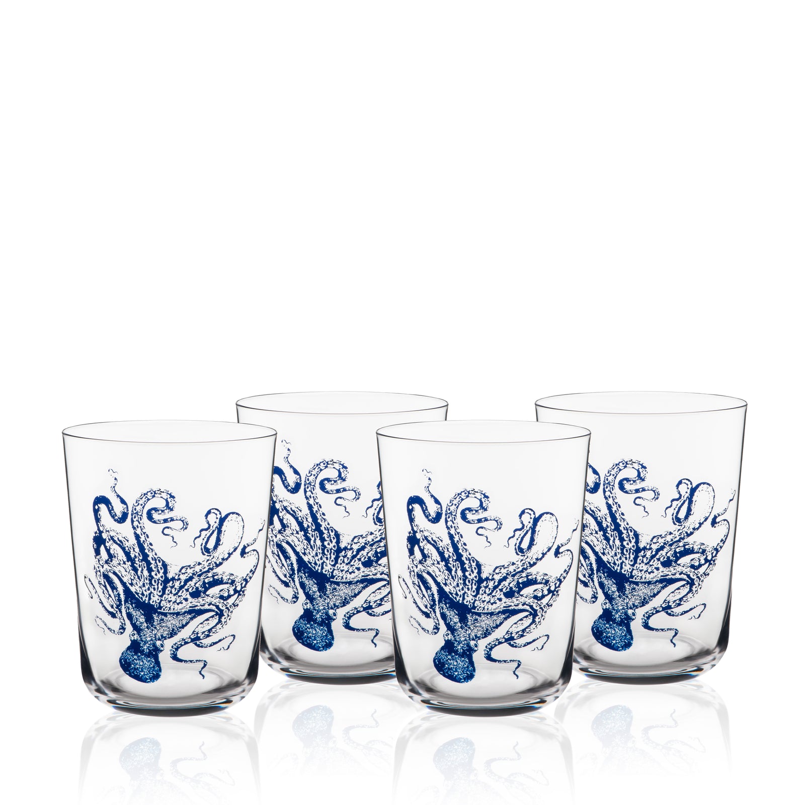 Four Caskata Lucy Blues Short Drinking Glasses, crafted from lead-free crystal and featuring blue octopus illustrations, are displayed in two rows against a white background.