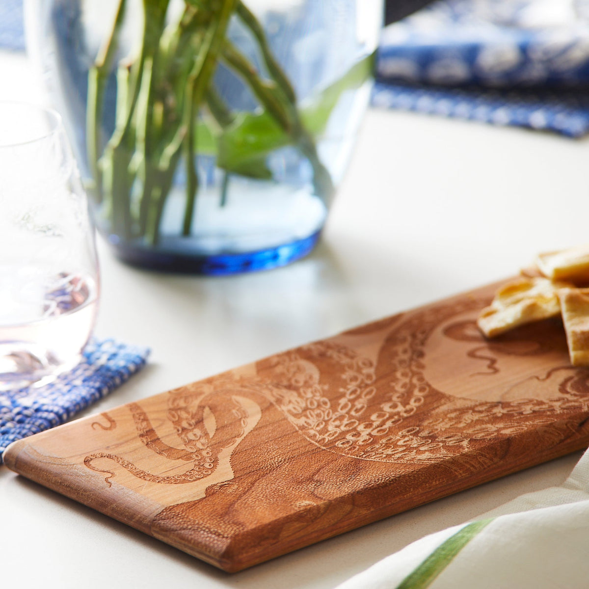 A Lucy Serving Board by Caskata with an octopus on it.