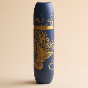 Caskata x High Camp Dark Blue Lucy Wine Flask in a cylindrical shape, decorated with a gold octopus illustration.