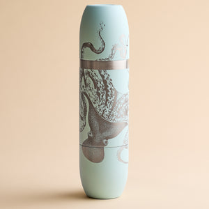 Caskata x High Camp Light Blue Lucy Wine Flask, a light blue cylindrical insulated flask featuring a detailed metallic octopus illustration.