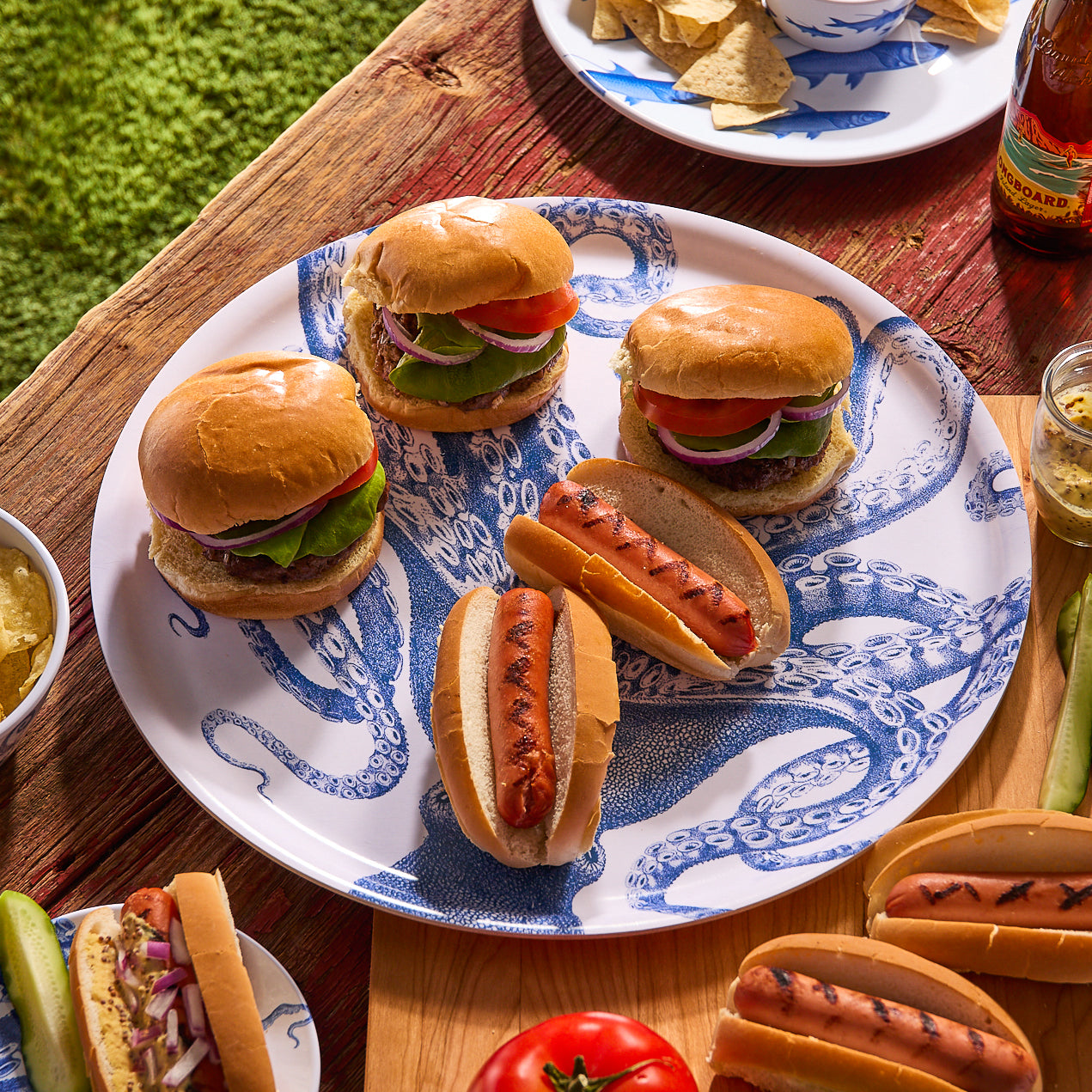 The Lucy Large Round Birchwood Tray by Caskata features a detailed blue octopus with intricate tentacles on a white background, adding nautical charm to sustainable entertaining.