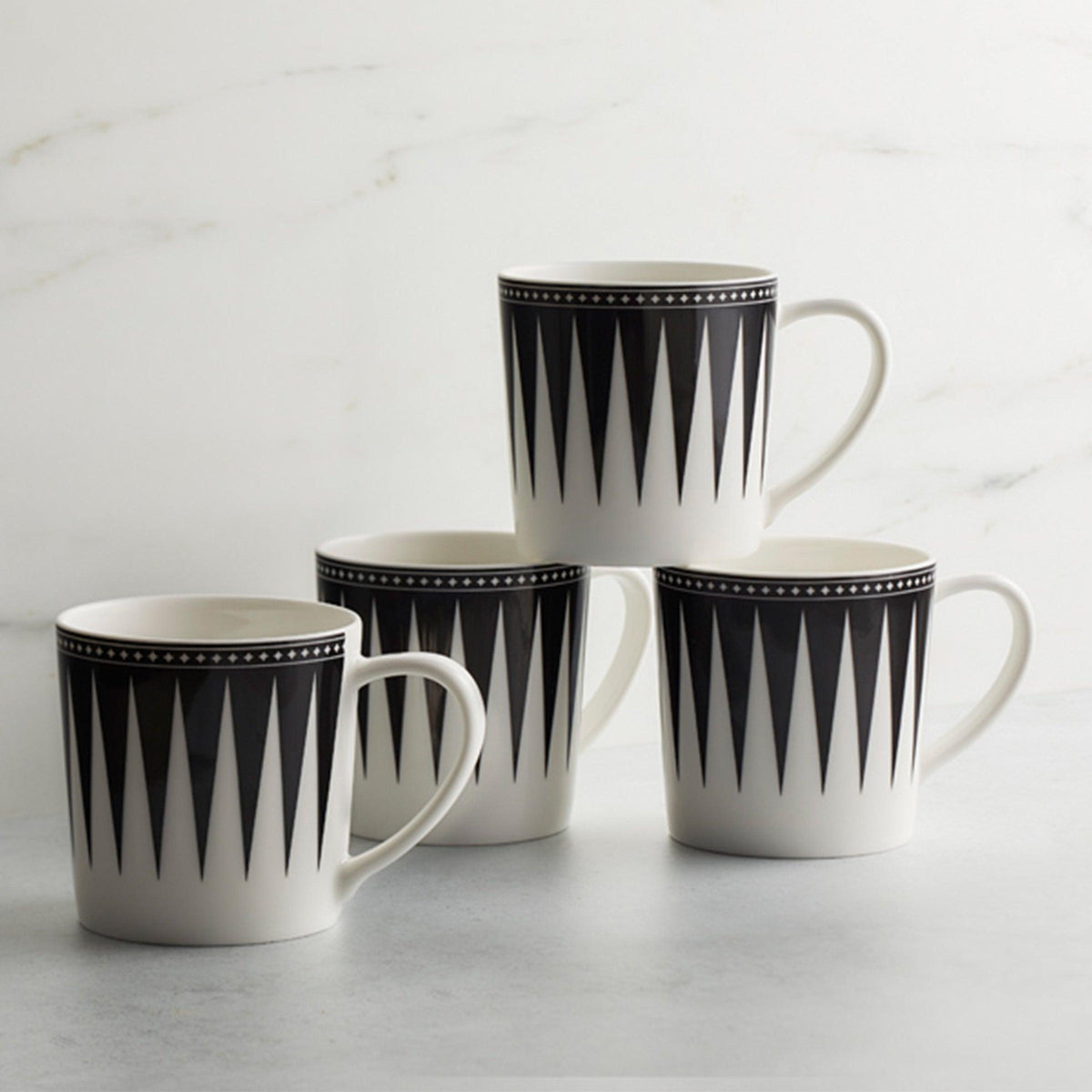 Four Marrakech Mug Black by Caskata Artisanal Home ceramics on a marble table.