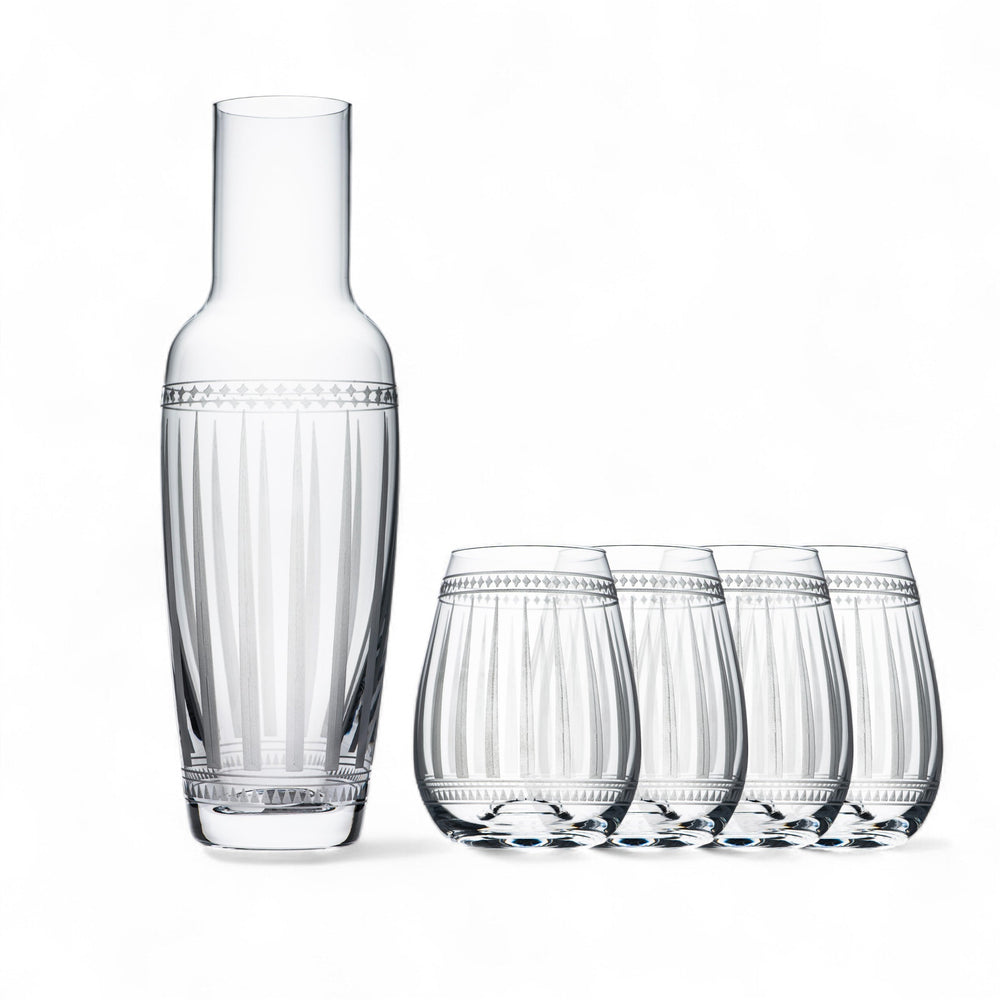 Caskata's A Pour for Friends Bundle features a clear glass carafe with vertical etched lines and four matching lead-free crystal stemless wine glasses, all elegantly displayed on a white background.