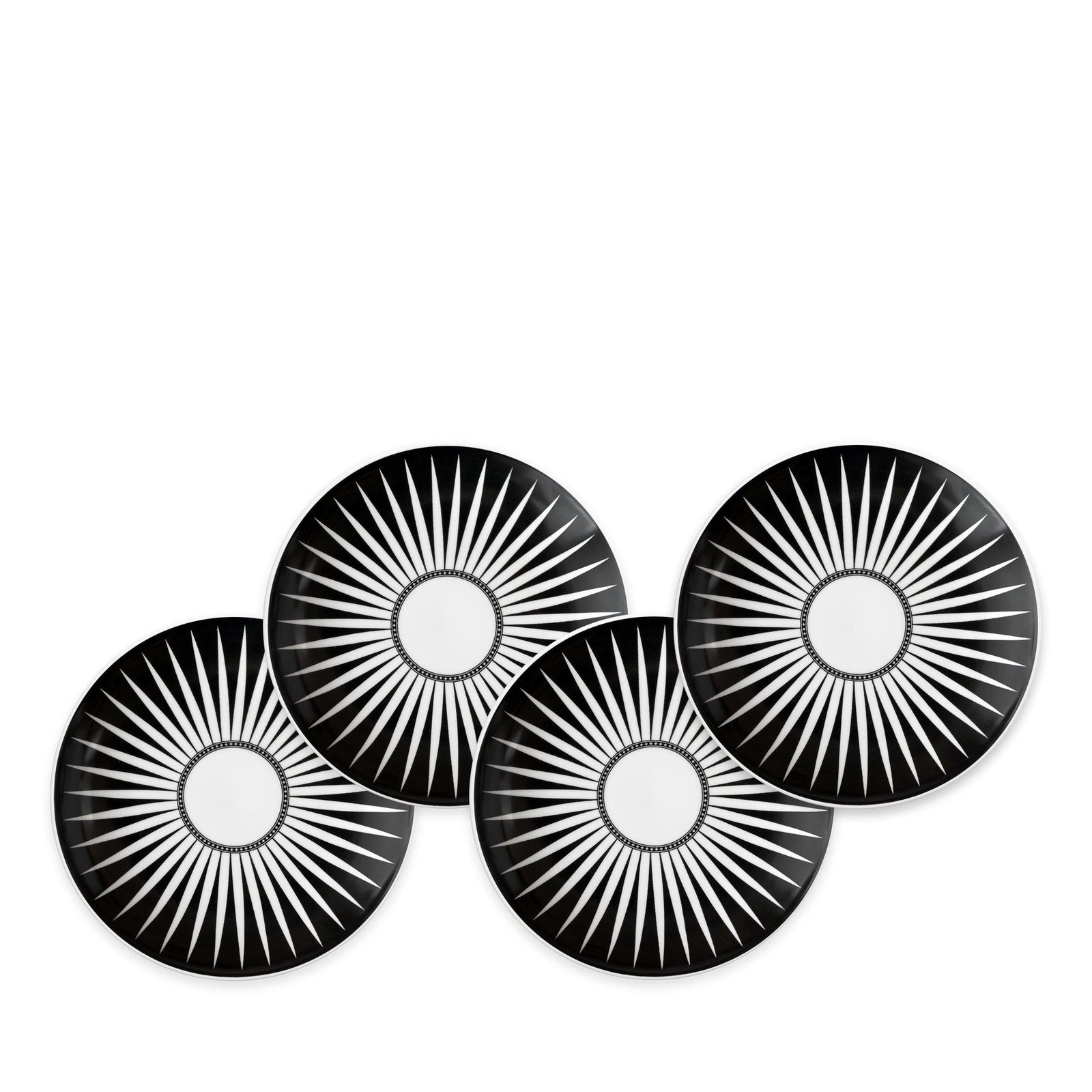 Four Marrakech Small Plates by Caskata Artisanal Home, each made of high-fired porcelain with white radial starburst patterns, are arranged in a staggered overlapping formation reminiscent of Marrakech's intricate designs.