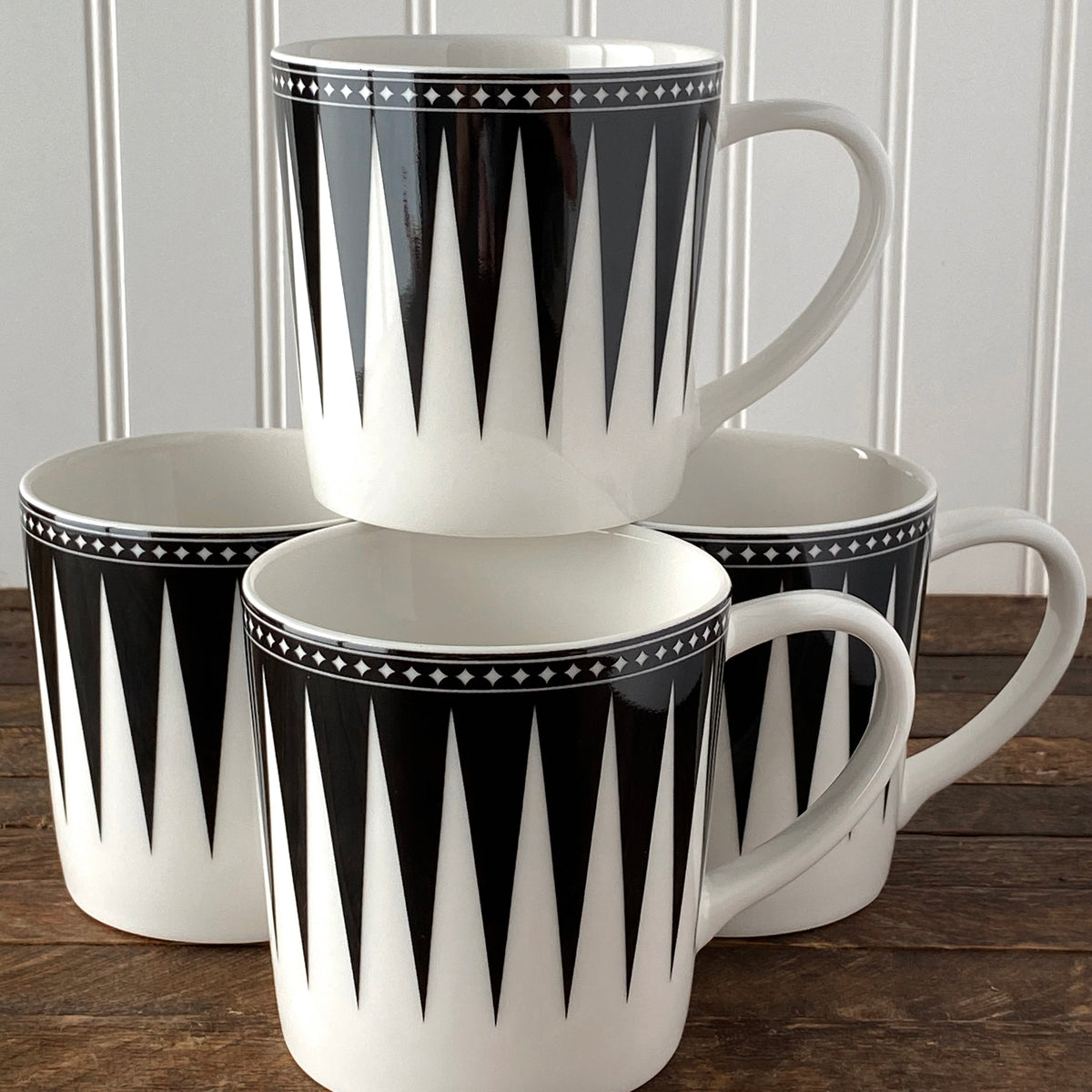 Four Marrakech Mug Black ceramic mugs stacked on top of each other.