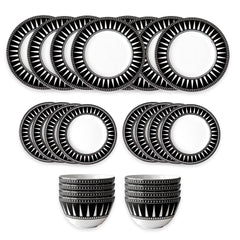 The Marrakech Table for 8 by Caskata is a 16-piece porcelain dinnerware set featuring black and white Art Deco geometric patterns, including eight plates, six side plates, and two bowls on a crisp white background.