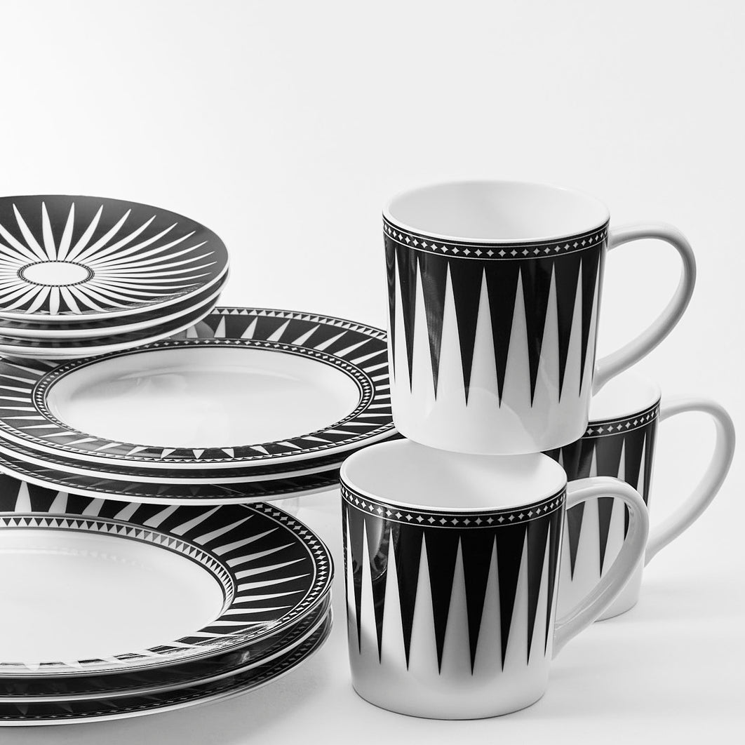 A stack of Caskata ceramics in Marrakech, featuring plates and mugs.