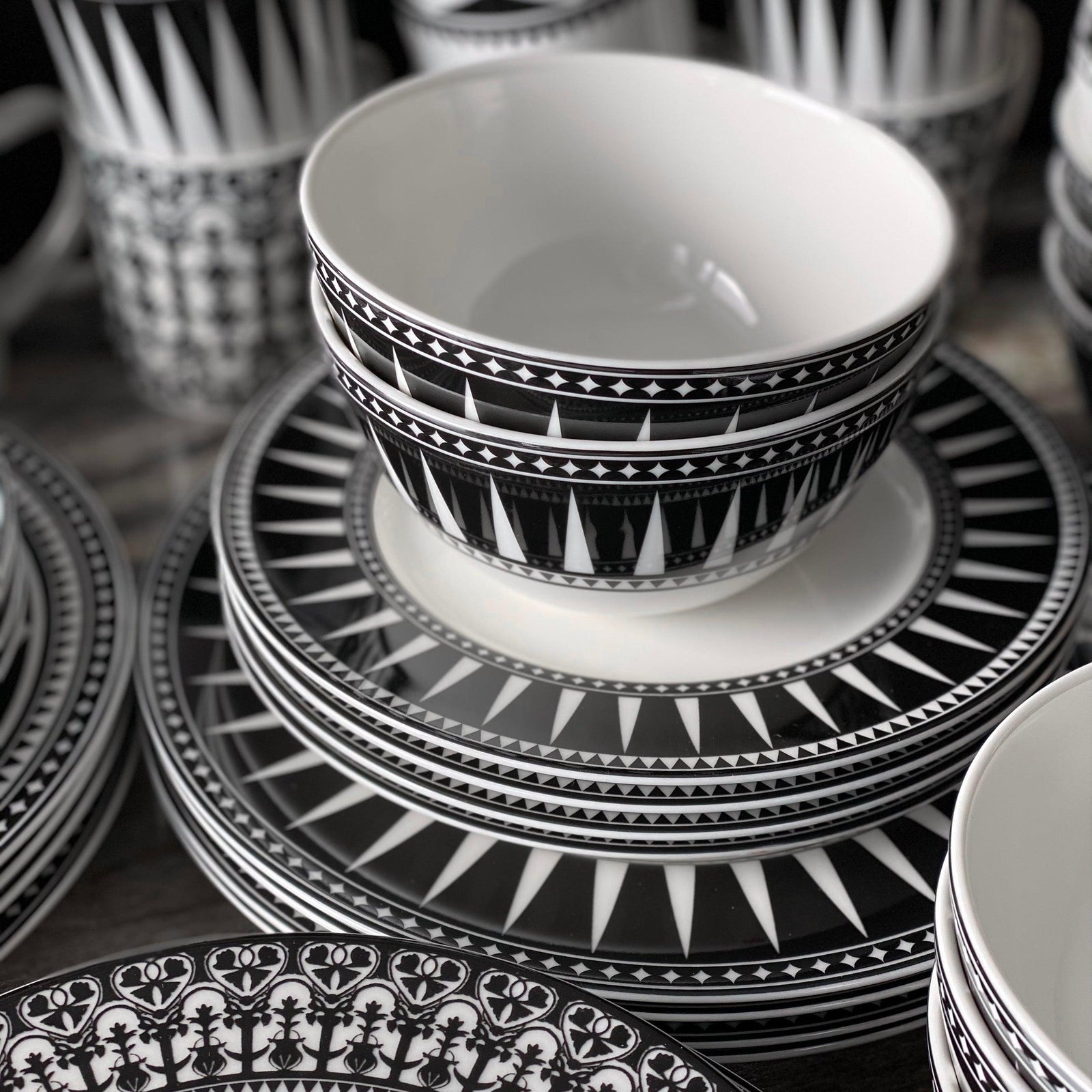 The Caskata Marrakech Ultimate Set is a 32-piece porcelain dinnerware collection with black and white patterned plates, bowls, cups, and an oval platter—artfully displayed on a white background.