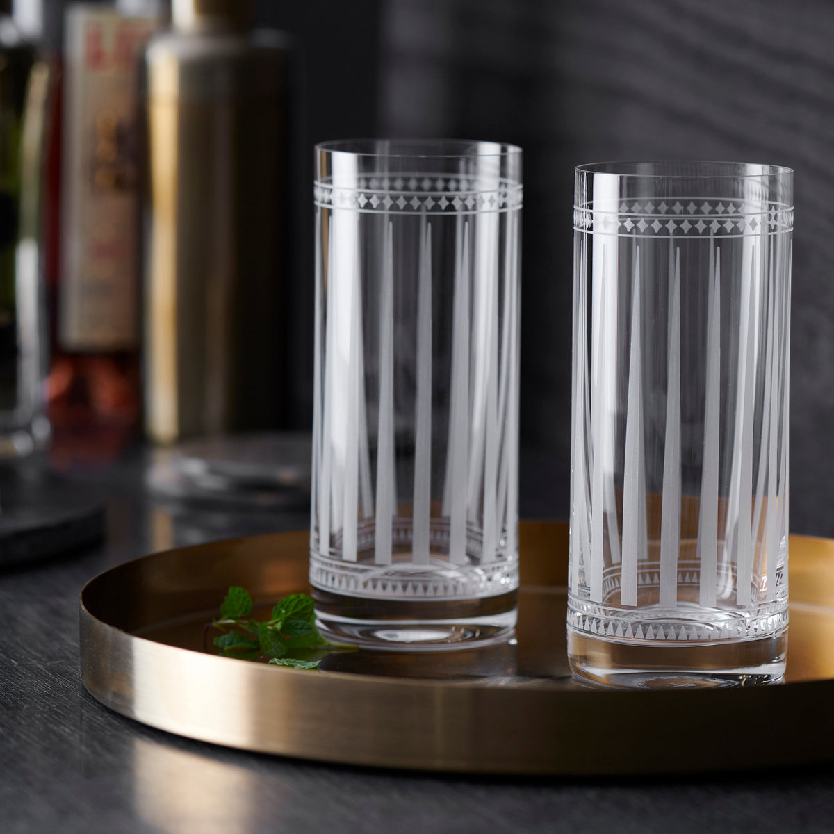 Two Marrakech Highball Glasses sitting on a tray next to a bar in Caskata Artisanal Home.