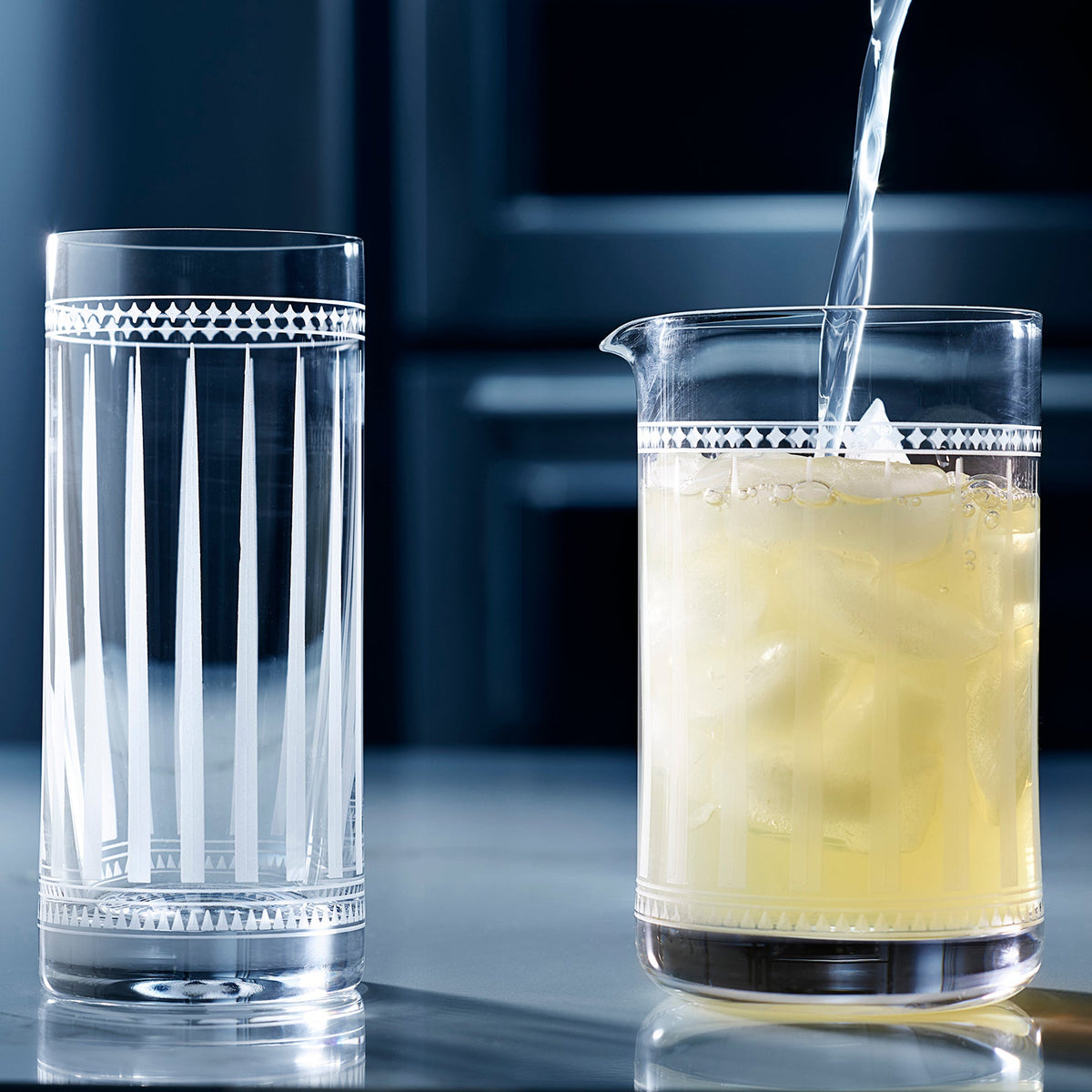 A glass of lemonade is being poured into a Marrakech Cocktail Collection-inspired glass by Caskata Artisanal Home.