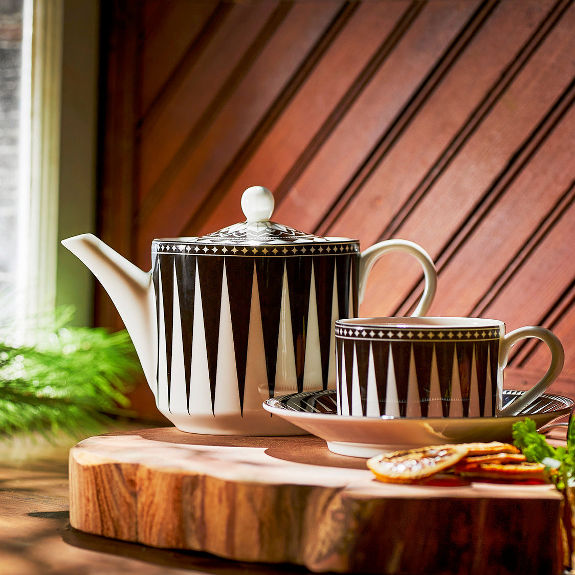 A Marrakech Petite Teapot by Caskata on a wooden cutting board.