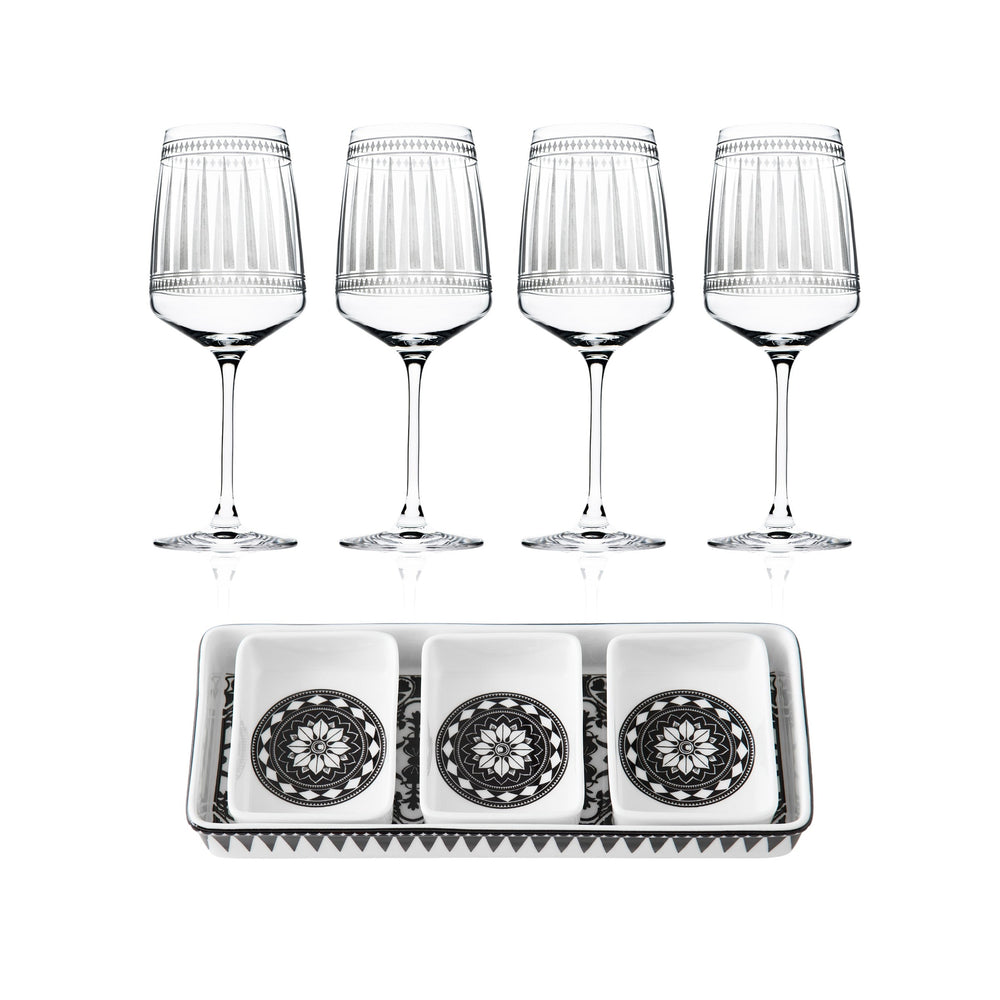 The Caskata Cocktail Hour Bundle includes four red wine glasses and a rectangular appetizer tray with three square dishes, each adorned with a black and white geometric design.