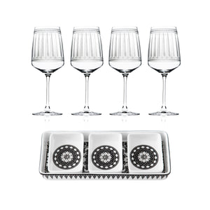 The Caskata Cocktail Hour Bundle includes four red wine glasses and a rectangular appetizer tray with three square dishes, each adorned with a black and white geometric design.