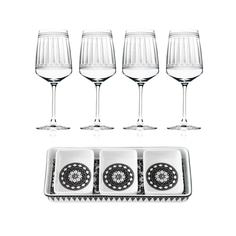 The "Cocktail Hour" Bundle by Caskata features four red wine glasses arranged above a rectangular appetizer tray with three small square dishes, each showcasing a striking black and white geometric design.